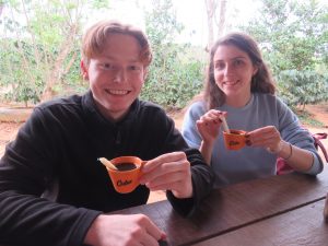 Trying the local coffee where it is grown. Sugar cane (which you suck on to release the sugar) is used instead of sugar grains to sweeten the coffee.