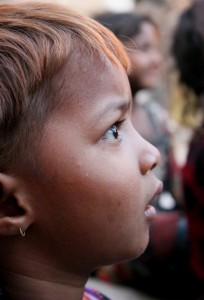 This young girl is being given some basic education along with about thirty of her peers. Classes took place once a week in the open air on a straw mat. 