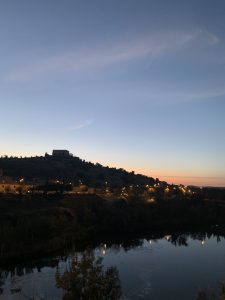 As the sun set behind the rolling hills of the horizon, the water reflected all the beautiful colours of the sky.