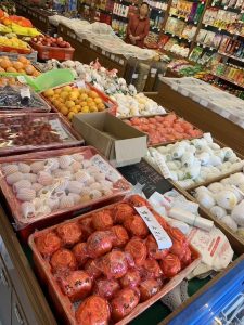 A Chinese fruit shop with almost every piece of fruit individually wrapped in plastic