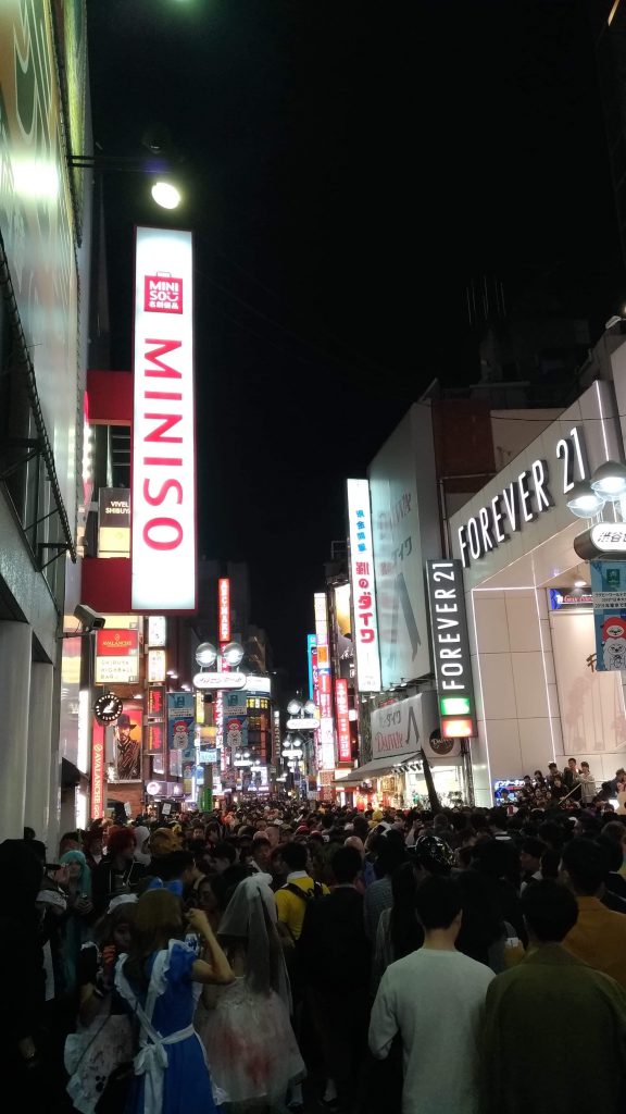 A street in Shibuya filled with people celebrating Halloween.